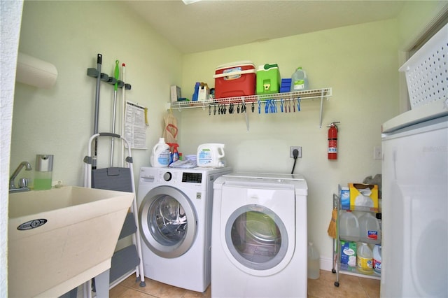 10 Armbruster Ct, Frostproof, FL 33843 - washroom with light tile patterned flooring and independent washer and dryer