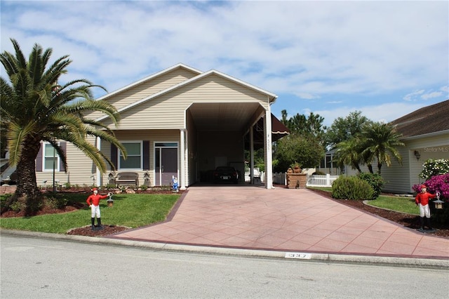 view of front facade featuring a front lawn and a carport