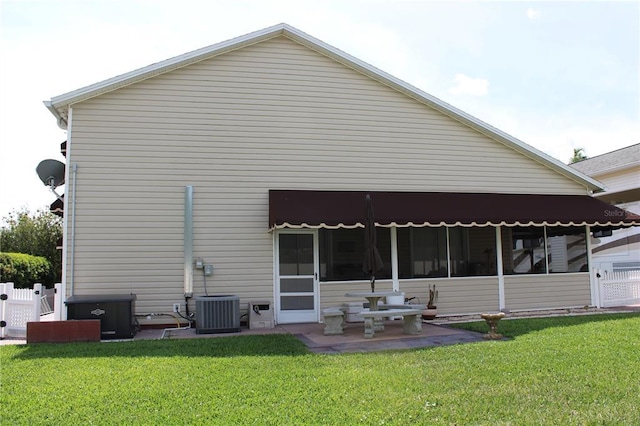 back of house featuring a yard, a patio area, and central air condition unit