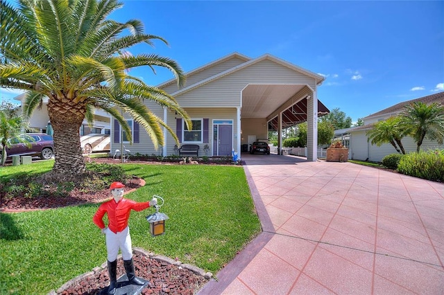 view of front of property with a front yard and a carport