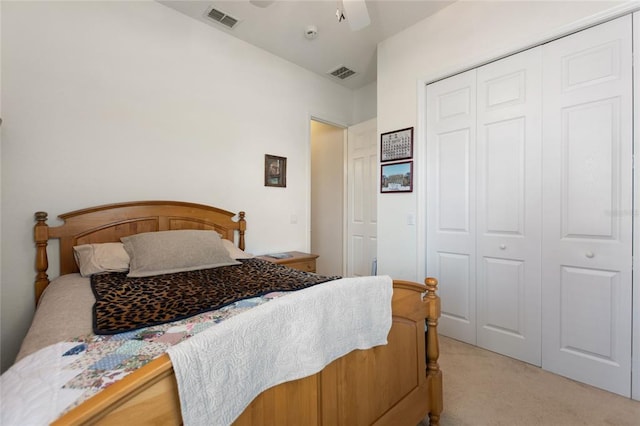 carpeted bedroom featuring a closet and ceiling fan