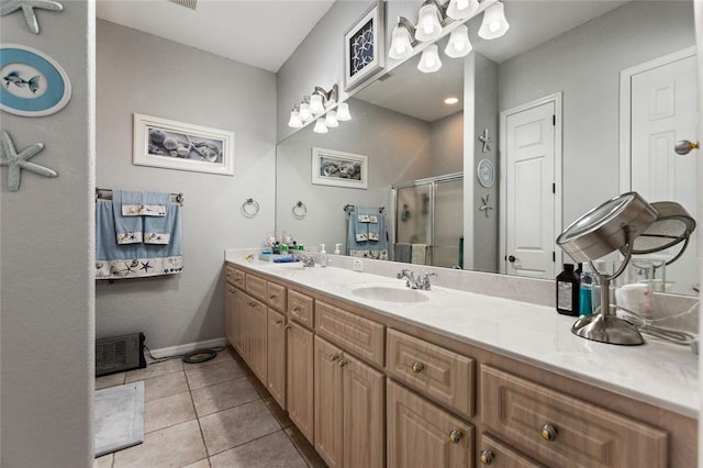 bathroom with oversized vanity, tile floors, and walk in shower