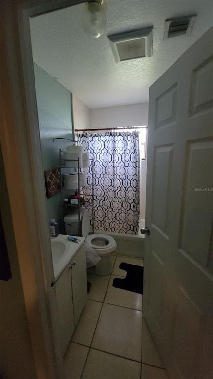 bathroom with toilet, tile flooring, and vanity