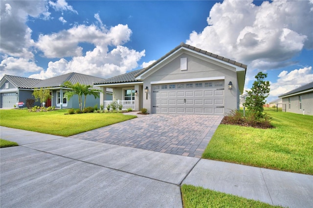 ranch-style home featuring a garage and a front lawn