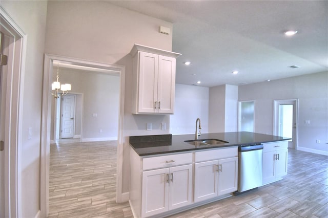 kitchen featuring stainless steel dishwasher, sink, white cabinets, and light wood-type flooring