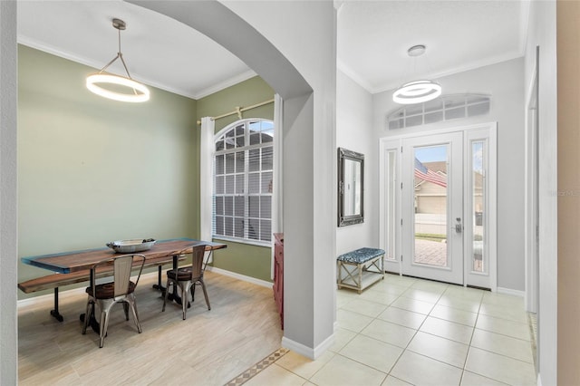 entryway with ornamental molding and light wood-type flooring