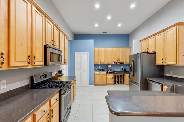 kitchen with light brown cabinetry, appliances with stainless steel finishes, light tile floors, and sink