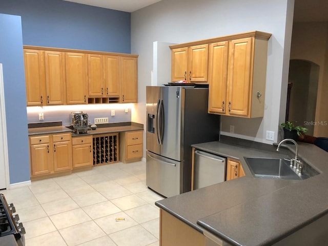 kitchen with light tile floors, sink, and stainless steel appliances