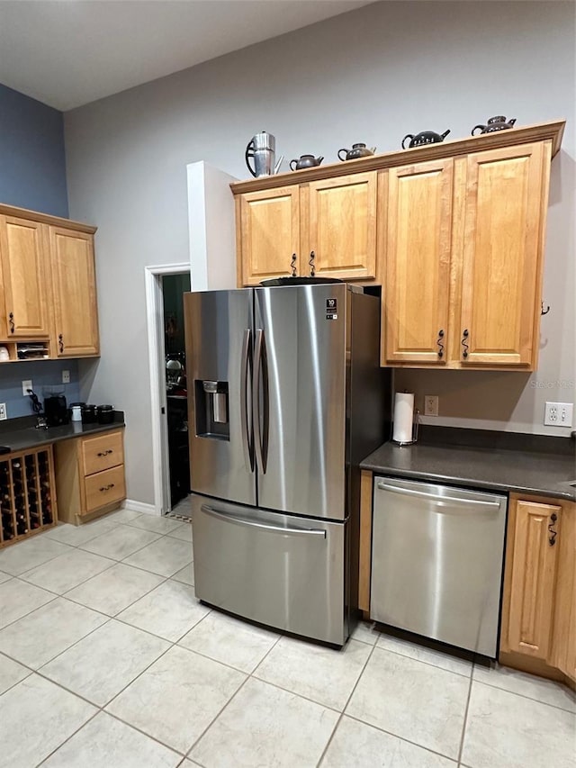 kitchen featuring appliances with stainless steel finishes and light tile floors