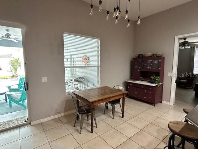 tiled dining room featuring plenty of natural light and ceiling fan