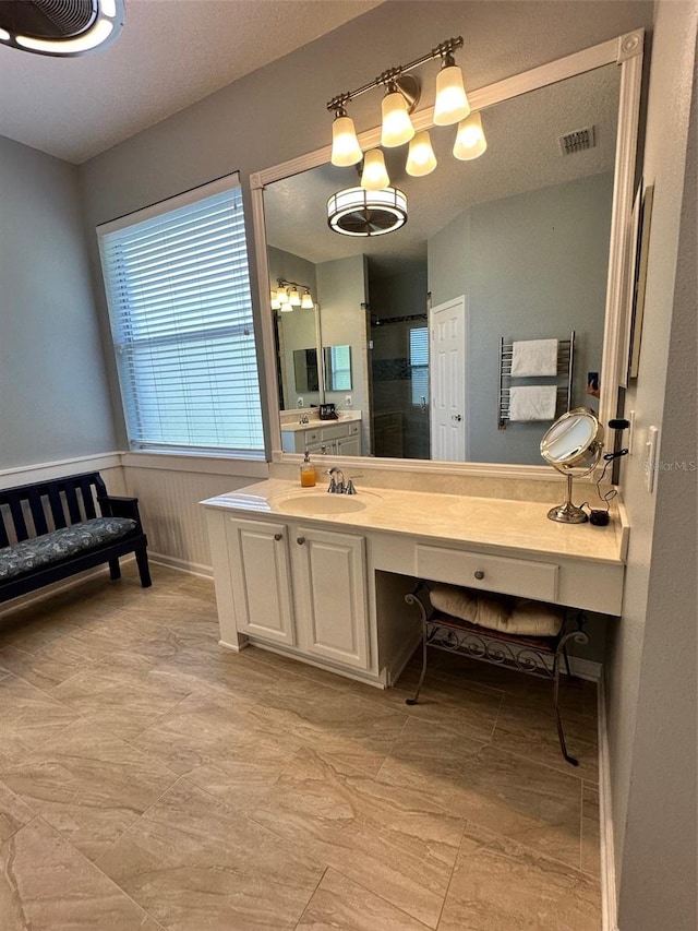 bathroom featuring tile flooring and oversized vanity