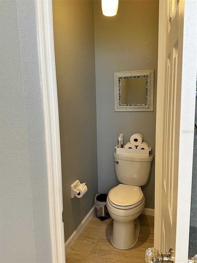 bathroom with hardwood / wood-style floors and toilet