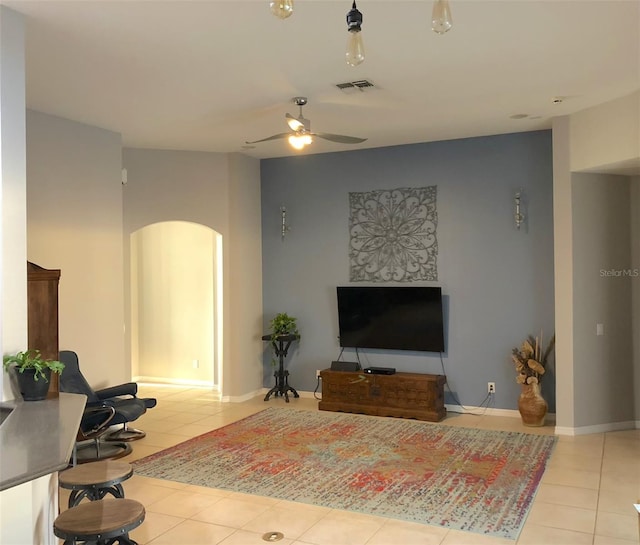 living room featuring ceiling fan and light tile floors