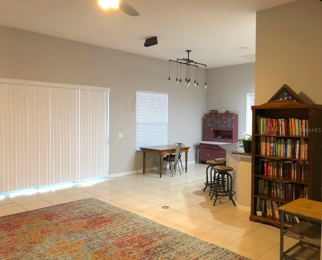 living area featuring light tile floors and ceiling fan