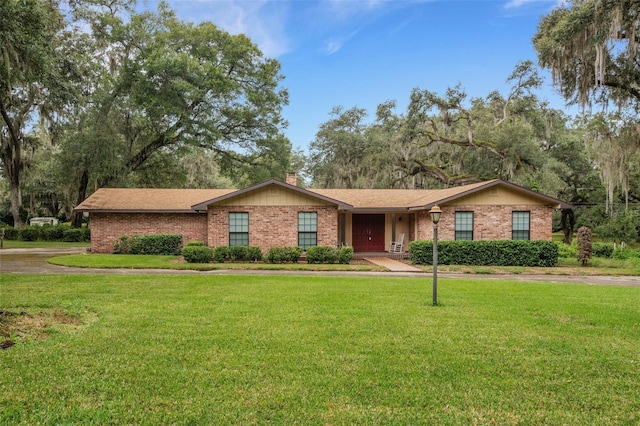 ranch-style home with a front lawn