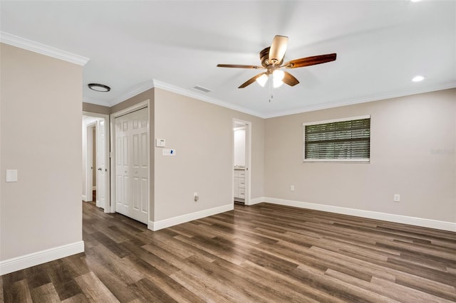 unfurnished room featuring ceiling fan, dark wood-type flooring, and ornamental molding