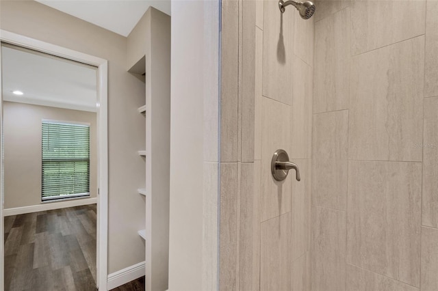 bathroom with hardwood / wood-style floors and a shower