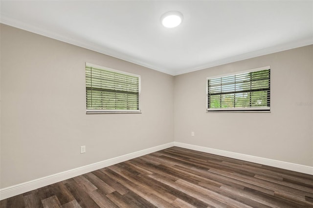 unfurnished room featuring dark hardwood / wood-style flooring and ornamental molding