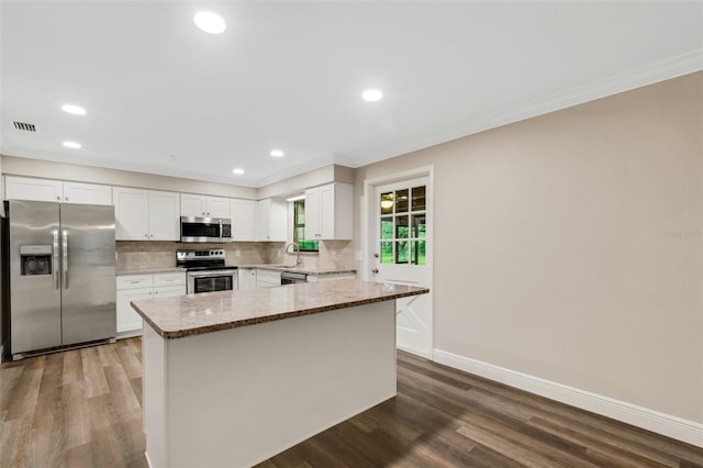 kitchen with white cabinetry, dark hardwood / wood-style flooring, and stainless steel appliances