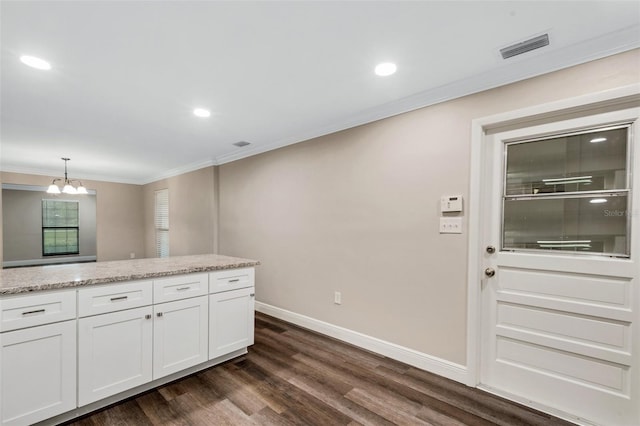 kitchen with dark hardwood / wood-style flooring, white cabinetry, a chandelier, and light stone countertops