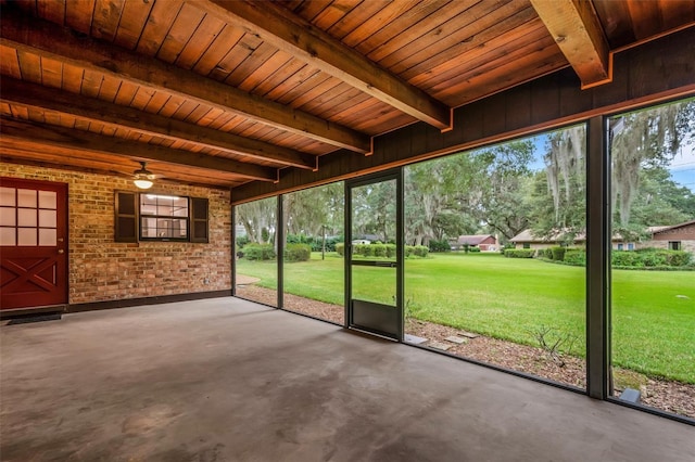 unfurnished sunroom with beam ceiling, wooden ceiling, and ceiling fan