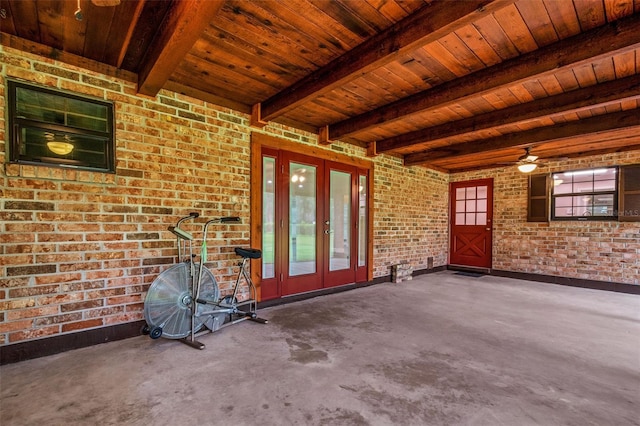 interior space featuring plenty of natural light, ceiling fan, brick wall, wood ceiling, and french doors