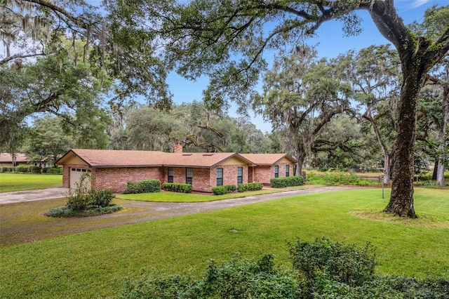 ranch-style house featuring a front yard and a garage