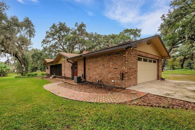 view of property exterior featuring central AC unit, a lawn, and a garage