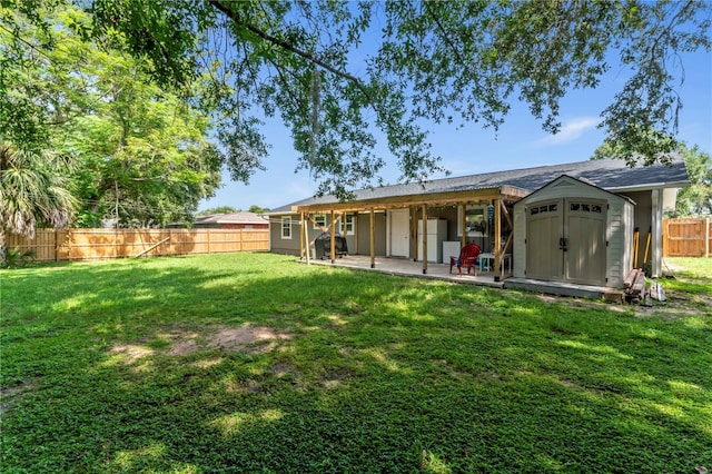 3016 Reiter Dr, Auburndale, FL 33823 - rear view of property with a patio, a yard, and a storage unit