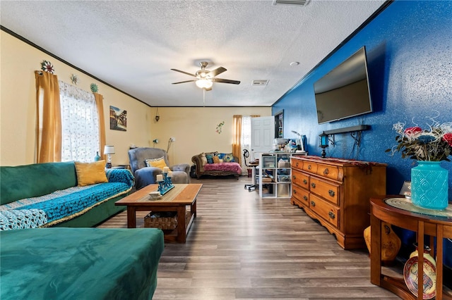 3016 Reiter Dr, Auburndale, FL 33823 - living room with dark wood-type flooring, ceiling fan, and a textured ceiling