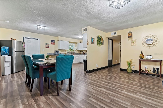 3016 Reiter Dr, Auburndale, FL 33823 - dining space featuring wood-type flooring and a textured ceiling