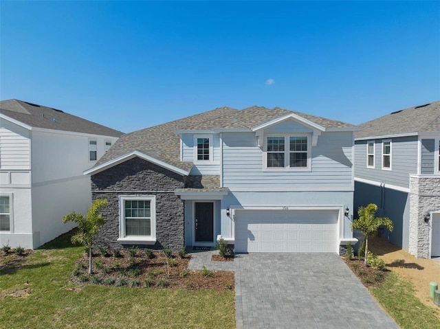 view of property with a front lawn and a garage