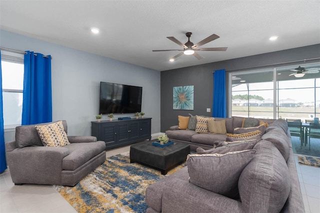 tiled living room with a textured ceiling and ceiling fan