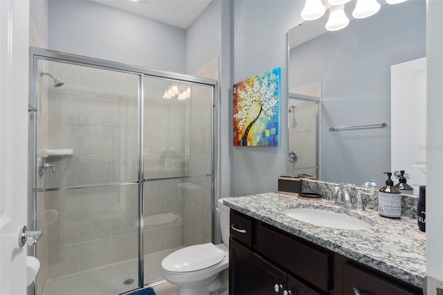 bathroom with vanity, toilet, and an enclosed shower