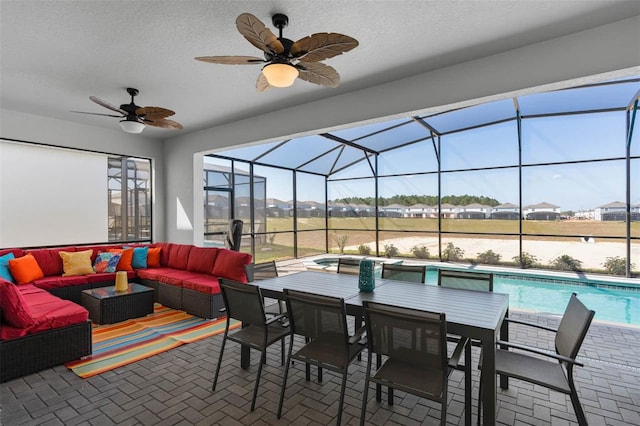 view of patio / terrace with an outdoor hangout area, ceiling fan, and a lanai