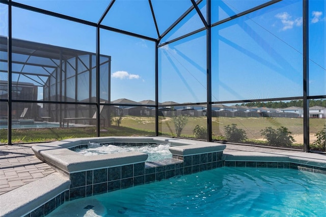 view of swimming pool with an in ground hot tub and glass enclosure