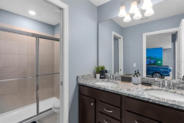 bathroom featuring vanity, a chandelier, toilet, and an enclosed shower