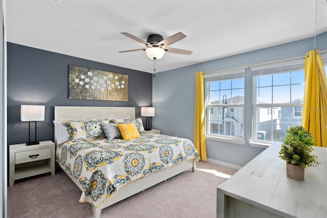 bedroom with carpet, a textured ceiling, and ceiling fan