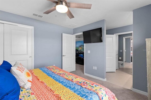 bedroom with a closet, ceiling fan, and light carpet