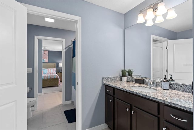 bathroom featuring vanity, toilet, and tile patterned flooring