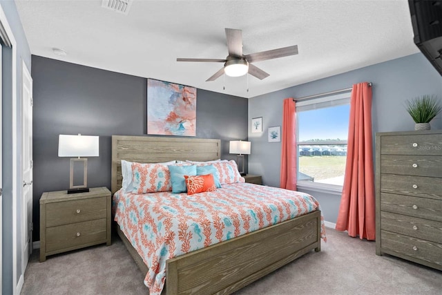 bedroom with light colored carpet and ceiling fan