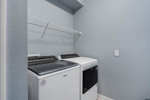 clothes washing area featuring washer and clothes dryer