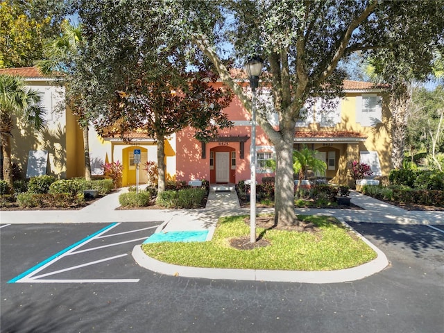 exterior space featuring uncovered parking and stucco siding