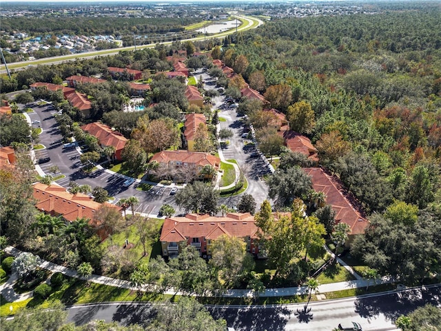 aerial view featuring a forest view and a residential view