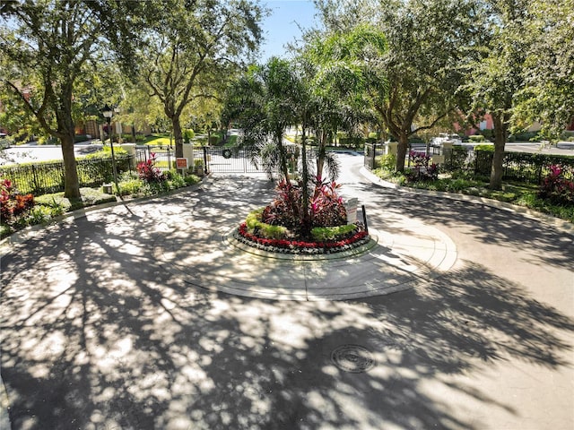 view of property's community with a gate and fence