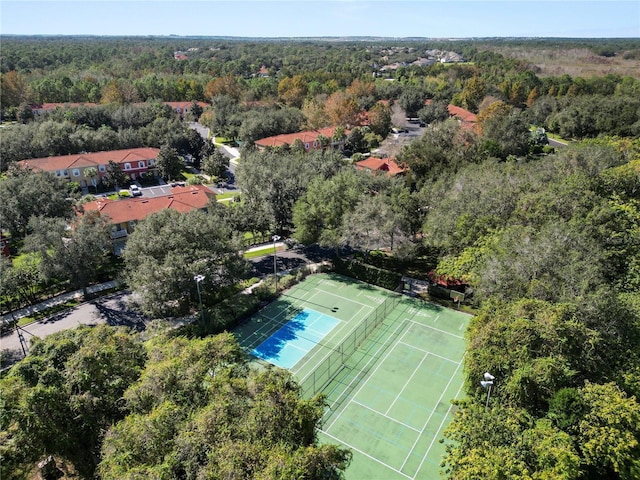 drone / aerial view with a wooded view