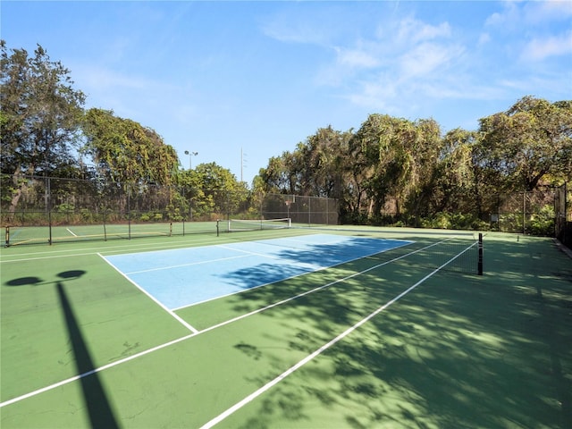 view of tennis court with fence