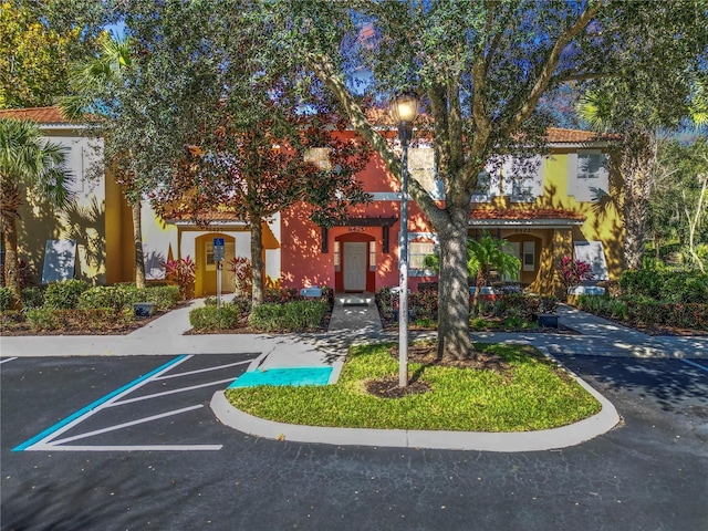 view of front of property featuring uncovered parking and stucco siding