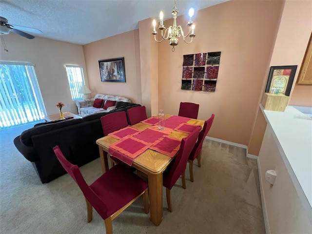 dining space with light carpet, baseboards, and ceiling fan with notable chandelier