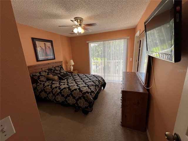 bedroom with access to outside, ceiling fan, a textured ceiling, and carpet